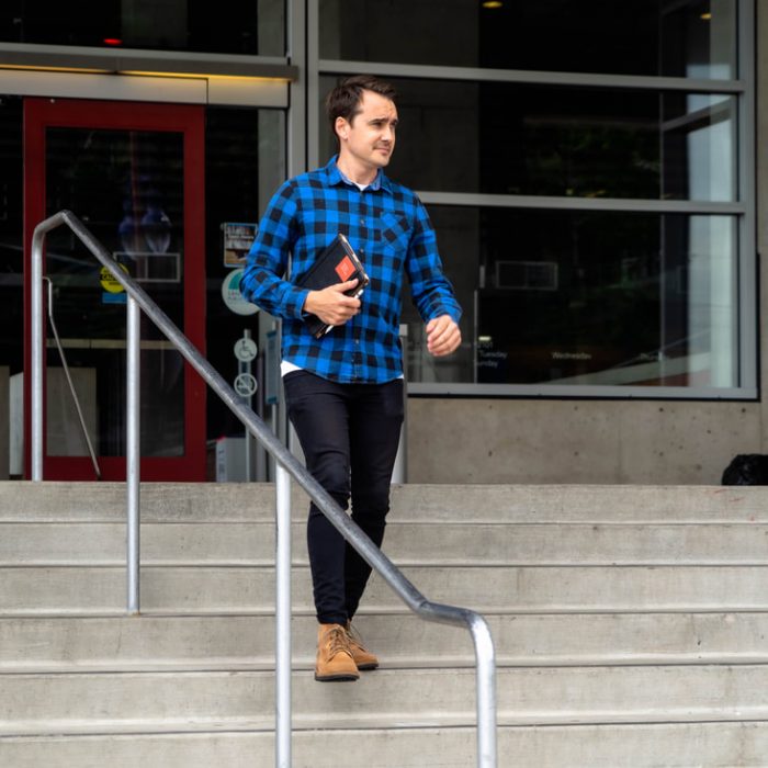 a picture of Josh Blakeley walking down the stairs